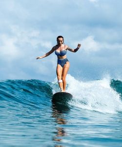 beautiful-girl-riding-on-surf-board-on-the-waves